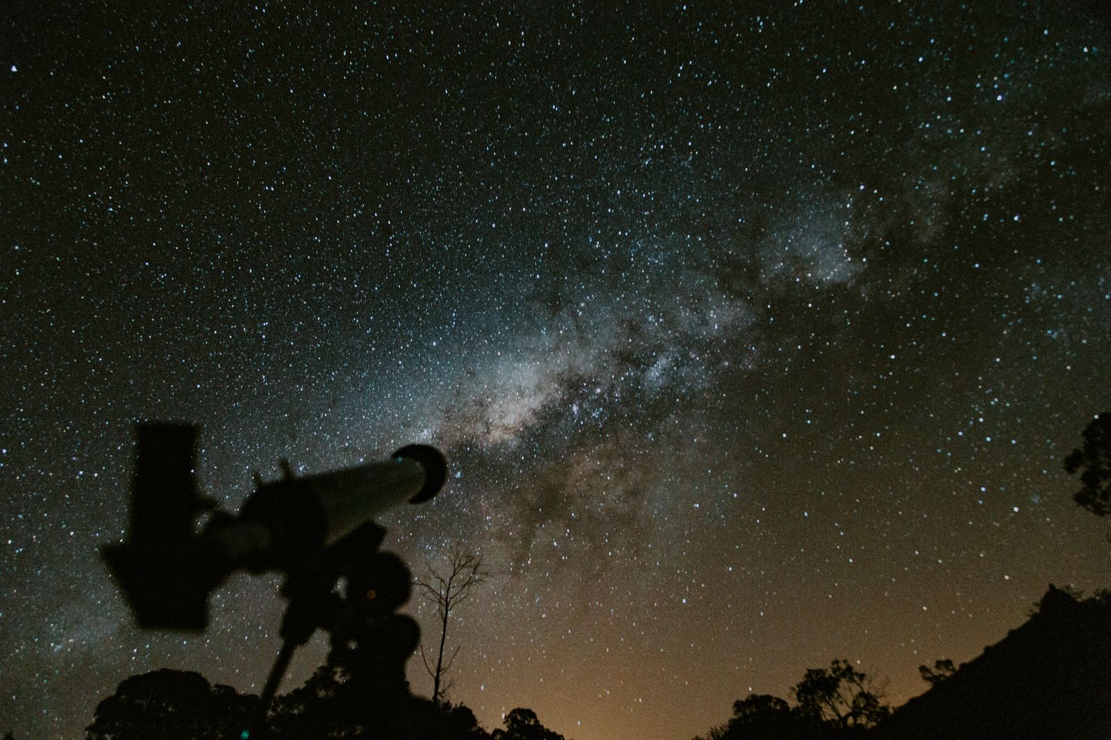 Telescope silhouetted against the Milky Way, a favorite subject of astronomy hobby cruises